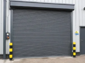 Industrial roller shutter door at warehouse entrance complying with roller shutter regulations UK for safe operation